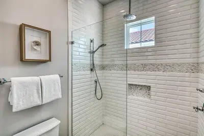 a bathroom with a shower with a glass door at Sanity By the Sea by 30A Escapes in Inlet Beach