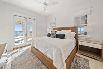 a white bedroom with a bed and a window at The Odessa by 30A Escapes in Seagrove Beach