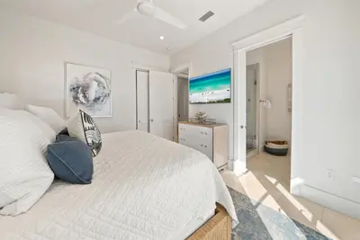 a white bedroom with a bed and a window at The Odessa by 30A Escapes in Seagrove Beach