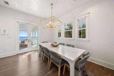 a dining room with a white table and chairs at The Odessa by 30A Escapes in Seagrove Beach