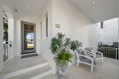 a porch with a chair and a potted plant at The Odessa by 30A Escapes in Seagrove Beach