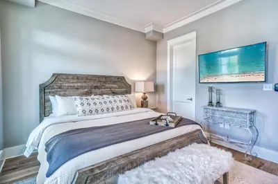 a bedroom with a large bed and a rug at 134 Walton Gulfview by 30A Escapes in Seacrest