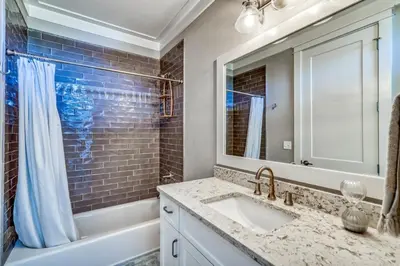 a bathroom with a sink and a tub and a mirror at 134 Walton Gulfview by 30A Escapes in Seacrest