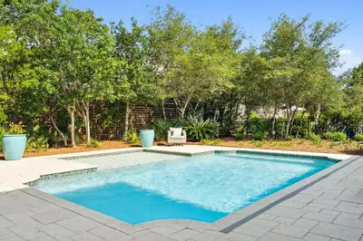 a swimming pool in a yard with trees at 134 Walton Gulfview by 30A Escapes in Seacrest