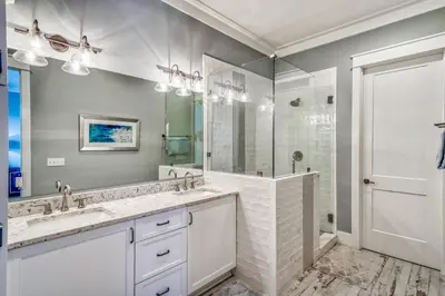 a bathroom with two sinks and a large mirror at 134 Walton Gulfview by 30A Escapes in Seacrest
