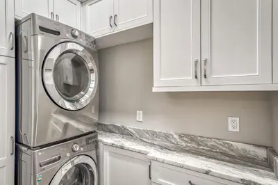 a kitchen with a washer and dryer in a kitchen at 134 Walton Gulfview by 30A Escapes in Seacrest
