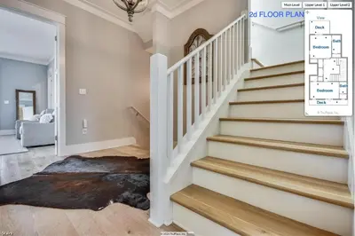 a staircase in a home with white walls and wood floors at 134 Walton Gulfview by 30A Escapes in Seacrest
