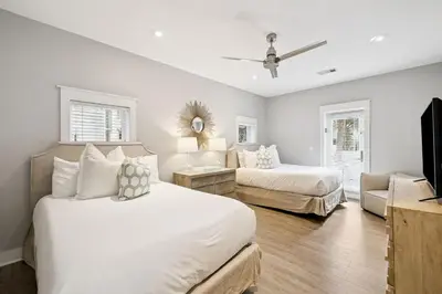 a bedroom with two beds and a living room at Casablanca by 30A Escapes in Rosemary Beach