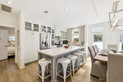 a kitchen with a large island with bar stools at Casablanca by 30A Escapes in Rosemary Beach