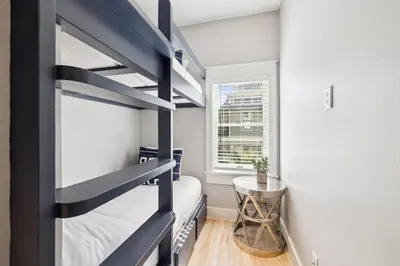 a small room with a bunk bed and a table at Casablanca by 30A Escapes in Rosemary Beach