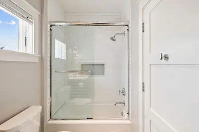a shower with a glass door in a bathroom at Casablanca by 30A Escapes in Rosemary Beach
