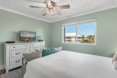 a bedroom with a bed and a ceiling fan at Searenity Now by 30A Escapes in Seagrove Beach