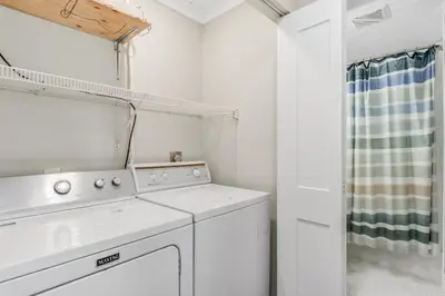 a white laundry room with a washer and dryer at Searenity Now by 30A Escapes in Seagrove Beach