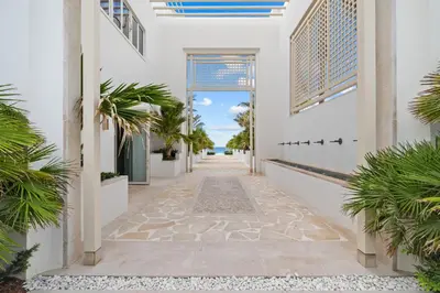 a hallway of a house with palm trees at Kaiya Beach Resort in Inlet Beach