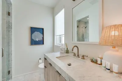 a bathroom with a sink and a mirror at Kaiya Beach Resort in Inlet Beach