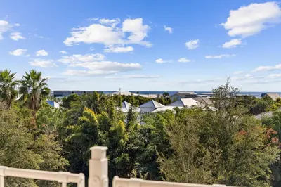 a view from the balcony of a house with trees at Kaiya Beach Resort in Inlet Beach