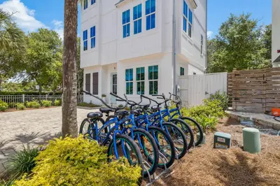 a row of blue bikes parked in front of a building at Dune Our Thing by 30A Escapes in Inlet Beach