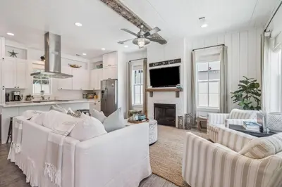 a living room with white furniture and a fireplace at Dune Our Thing by 30A Escapes in Inlet Beach