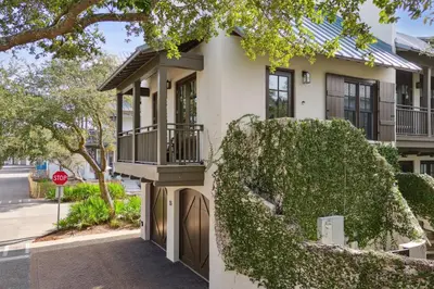 a house with a balcony on a street at Pappas Carriage by 30A Escapes in Rosemary Beach