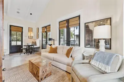 a living room with a couch and a table at Pappas Carriage by 30A Escapes in Rosemary Beach