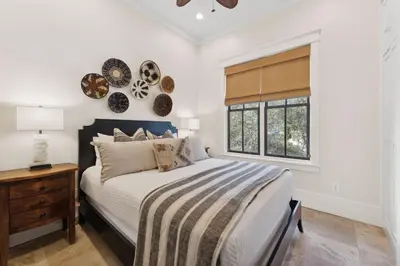 a bedroom with a bed and a window at Pappas Carriage by 30A Escapes in Rosemary Beach