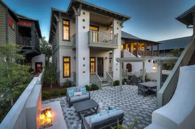 a house with a patio with a table and chairs at Summer Cottage by 30A Escapes in Rosemary Beach