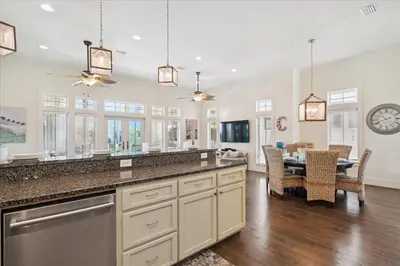 a large kitchen with a table and a dining room at Summer Cottage by 30A Escapes in Rosemary Beach