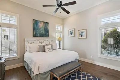 a bedroom with a bed and a ceiling fan at Summer Cottage by 30A Escapes in Rosemary Beach