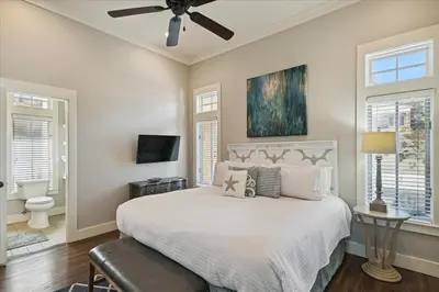 a bedroom with a bed and a ceiling fan at Summer Cottage by 30A Escapes in Rosemary Beach
