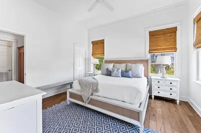 a white bedroom with a bed and a window at Barefoot Too by 30A Escapes in Inlet Beach
