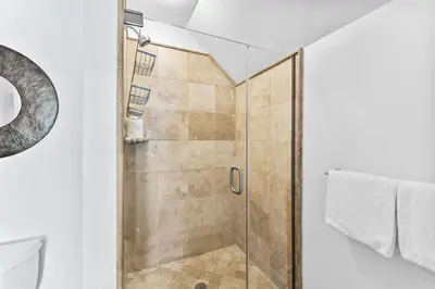 a shower with a glass door in a bathroom at Barefoot Too by 30A Escapes in Inlet Beach