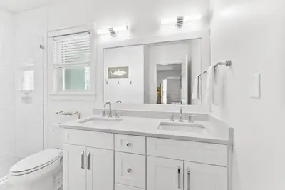 a white bathroom with a sink and a toilet at Barefoot Too by 30A Escapes in Inlet Beach