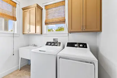 a laundry room with a washer and dryer at Barefoot Too by 30A Escapes in Inlet Beach