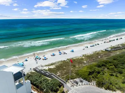 an overhead view of a beach with people and umbrellas at Barefoot Too by 30A Escapes in Inlet Beach