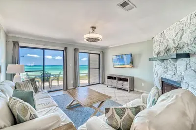 a living room with a couch and a fireplace at Mermaid Cove by 30A Escapes in Seacrest