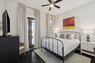 a bedroom with a bed and a ceiling fan at Somerset Cottage by 30A Escapes in Rosemary Beach