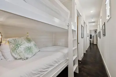 a white bunk bed in a white room at Somerset Cottage by 30A Escapes in Rosemary Beach