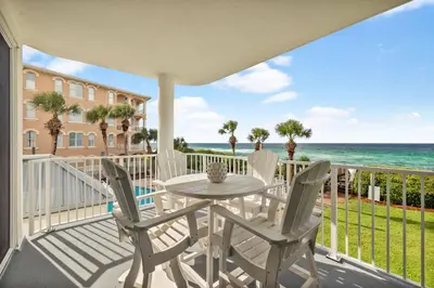 a balcony with a table and chairs and the ocean at Tranquillity on 30A Unit# 210 by 30A Escapes in Seacrest