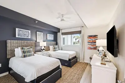 a bedroom with two beds and a television in it at Tranquillity on 30A Unit# 210 by 30A Escapes in Seacrest