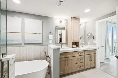 a bathroom with a tub and a sink and mirror at Tranquillity on 30A Unit# 210 by 30A Escapes in Seacrest