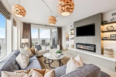 a living room with a couch and a fireplace at Tranquillity on 30A Unit# 210 by 30A Escapes in Seacrest