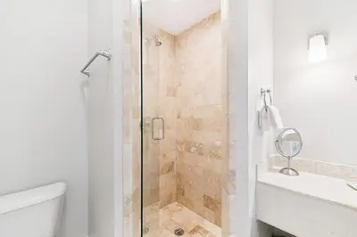 a bathroom with a shower and a toilet and a sink at 21 Hamilton Lane by 30A Escapes in Rosemary Beach