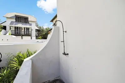 a stairway leading up to a white wall with a house at 21 Hamilton Lane by 30A Escapes in Rosemary Beach