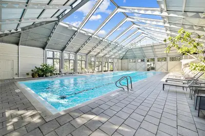 an indoor swimming pool with a glass ceiling at 21 Hamilton Lane by 30A Escapes in Rosemary Beach