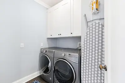 a washing machine in a laundry room with white cabinets at 21 Hamilton Lane by 30A Escapes in Rosemary Beach