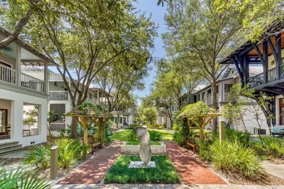 a statue in a garden in front of a building at Casita By The Sea by 30A Escapes in Rosemary Beach