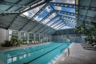 an indoor swimming pool with a glass ceiling at Casita By The Sea by 30A Escapes in Rosemary Beach