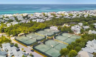 an overhead view of two tennis courts with the ocean at Casita By The Sea by 30A Escapes in Rosemary Beach