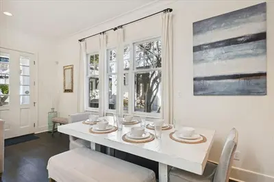 a dining room with a white table and chairs at Casita By The Sea by 30A Escapes in Rosemary Beach