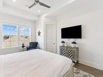 a bedroom with a bed and a flat screen tv at CaSEAta by 30A Escapes in Rosemary Beach